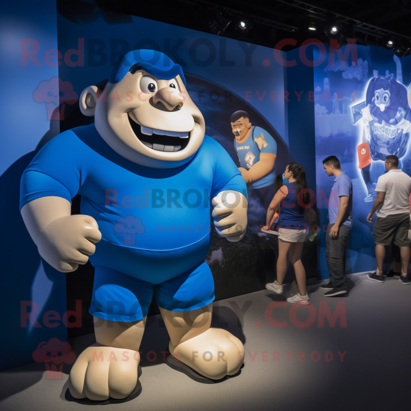 Blue Strongman mascot costume character dressed with a Polo Tee and Watches Blue Strongman mascot costume character dressed with a Polo Tee and Watches