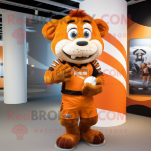 Orange Momentum mascot costume character dressed with a Rugby Shirt and Wraps