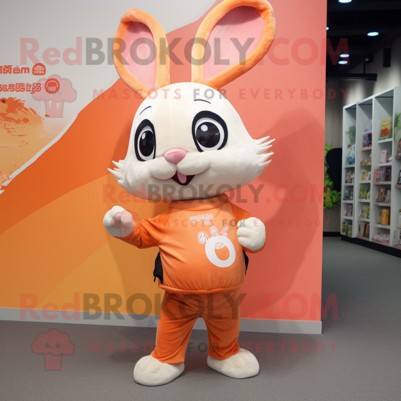 Peach Wild Rabbit mascot costume character dressed with a Graphic Tee and Brooches