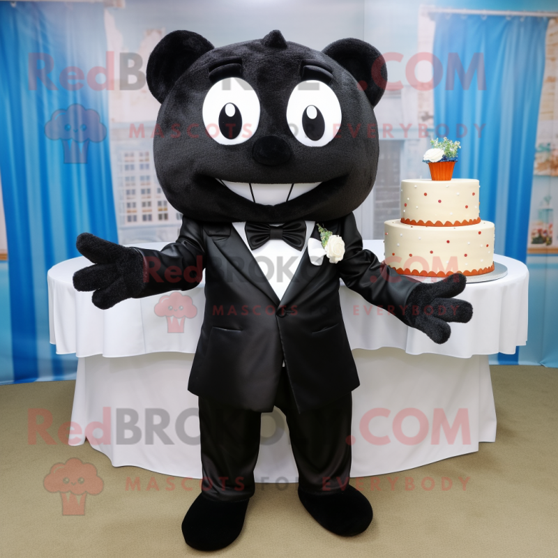 Black Wedding Cake mascot costume character dressed with a Sweatshirt and Bow ties Black Wedding Cake mascot costume character dressed with a Sweatshirt and Bow ties