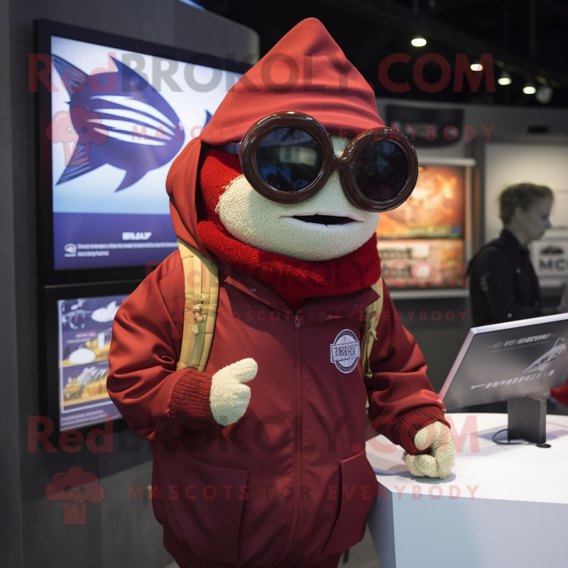Maroon Tuna mascot costume character dressed with a Parka and Reading glasses Maroon Tuna mascot costume character dressed with a Parka and Reading glasses