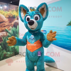 Turquoise Dingo mascot costume character dressed with a Swimwear and Bracelets