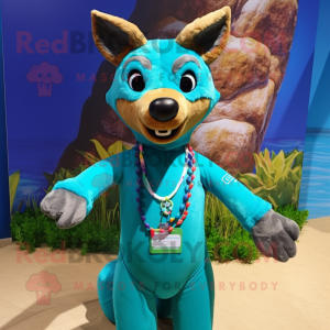 Turquoise Dingo mascot costume character dressed with a Swimwear and Bracelets