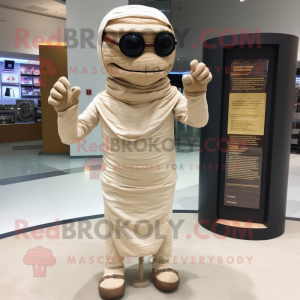 Tan Mummy mascot costume character dressed with a Blazer and Reading glasses