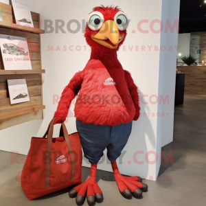 Red Guinea Fowl mascot costume character dressed with a Skinny Jeans and Tote bags