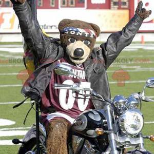 Mascote urso pardo com uma bandana e uma camisa esporte -