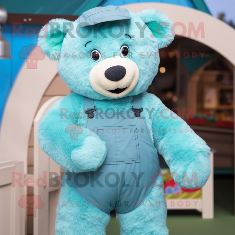 Turquoise Teddy Bear mascot costume character dressed with a Dungarees and Clutch bags Turquoise Teddy Bear mascot costume character dressed with a Dungarees and Clutch bags