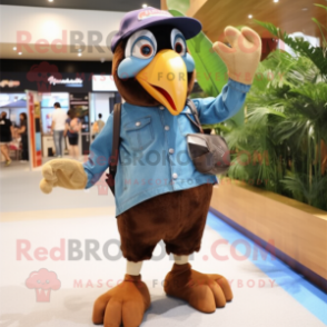 Brown Toucan mascot costume character dressed with a Denim Shorts and Mittens