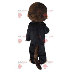 Kiki maskot slavné hnědé opice v černém oblečení -
