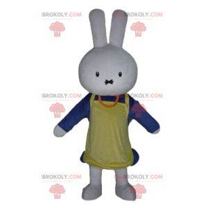 White rabbit mascot dressed in blue with an apron -