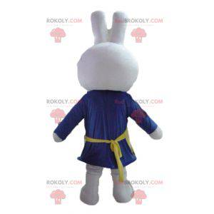 White rabbit mascot dressed in blue with an apron -