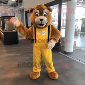 Gold Tamer Lion mascot costume character dressed with a Overalls and Mittens