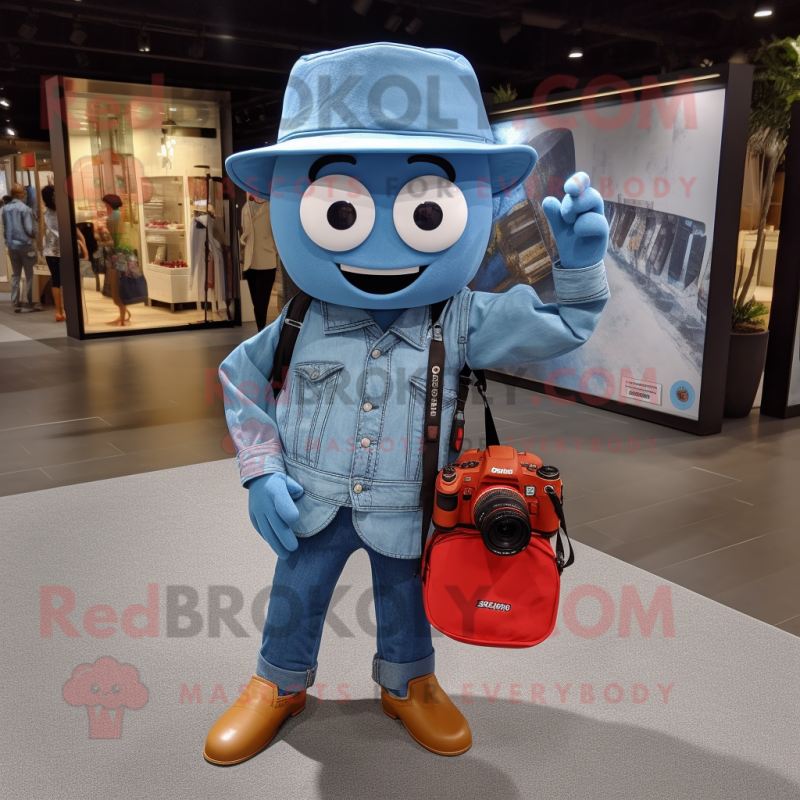 Blue Camera mascot costume character dressed with a Denim Shirt and Tote bags Blue Camera mascot costume character dressed with a Denim Shirt and Tote bags