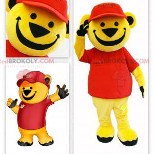 Mascote grande urso amarelo vestido de vermelho