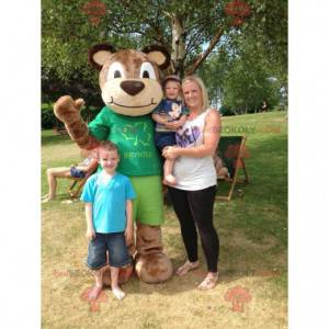 Brown teddy bear mascot in green outfit - Redbrokoly.com