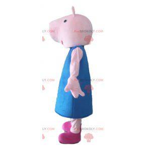 Rosa Schweinemaskottchen mit einem blauen Kleid - Redbrokoly.com