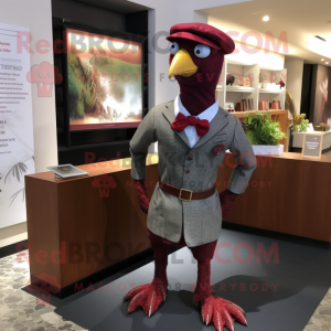 Maroon Guinea Fowl mascot costume character dressed with a Oxford Shirt and Berets