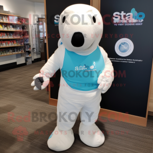 White Stellar'S Sea Cow mascot costume character dressed with a Bermuda Shorts and Smartwatches