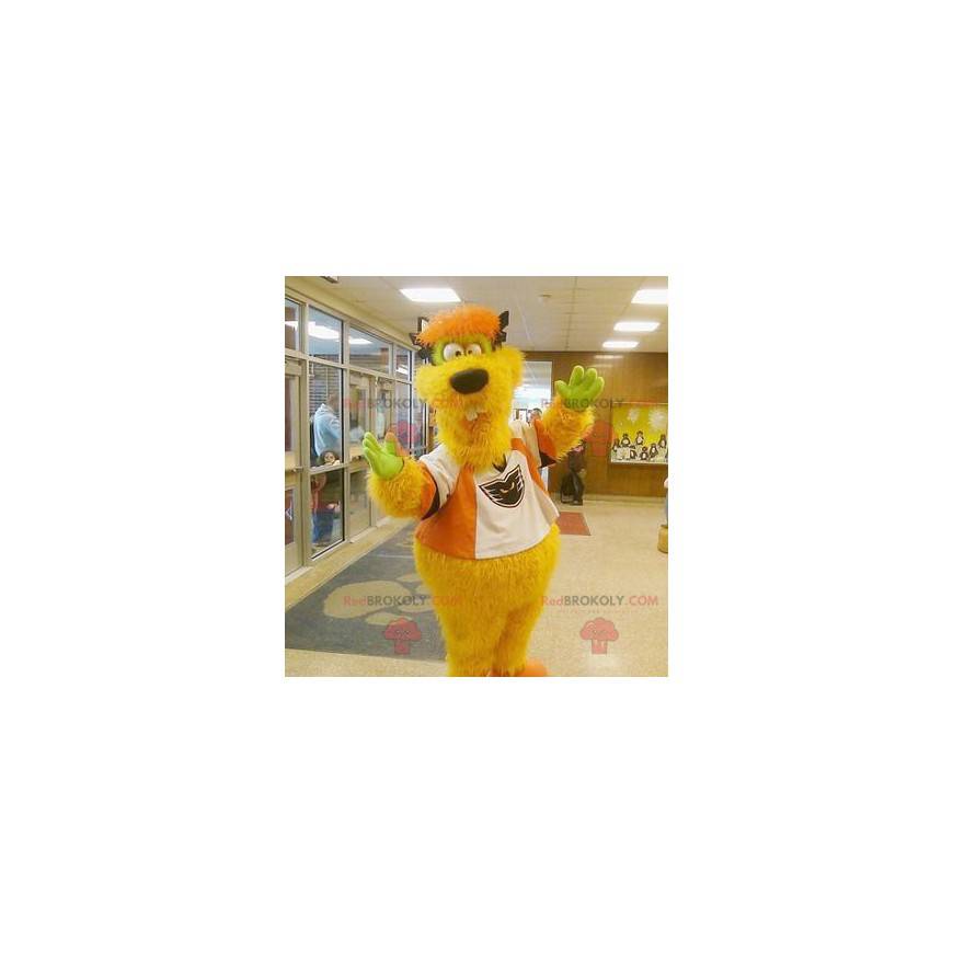 Mascota monstruo amarillo y naranja divertido y peludo -