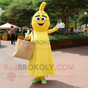 Yellow Zucchini mascot costume character dressed with a Empire Waist Dress and Tote bags