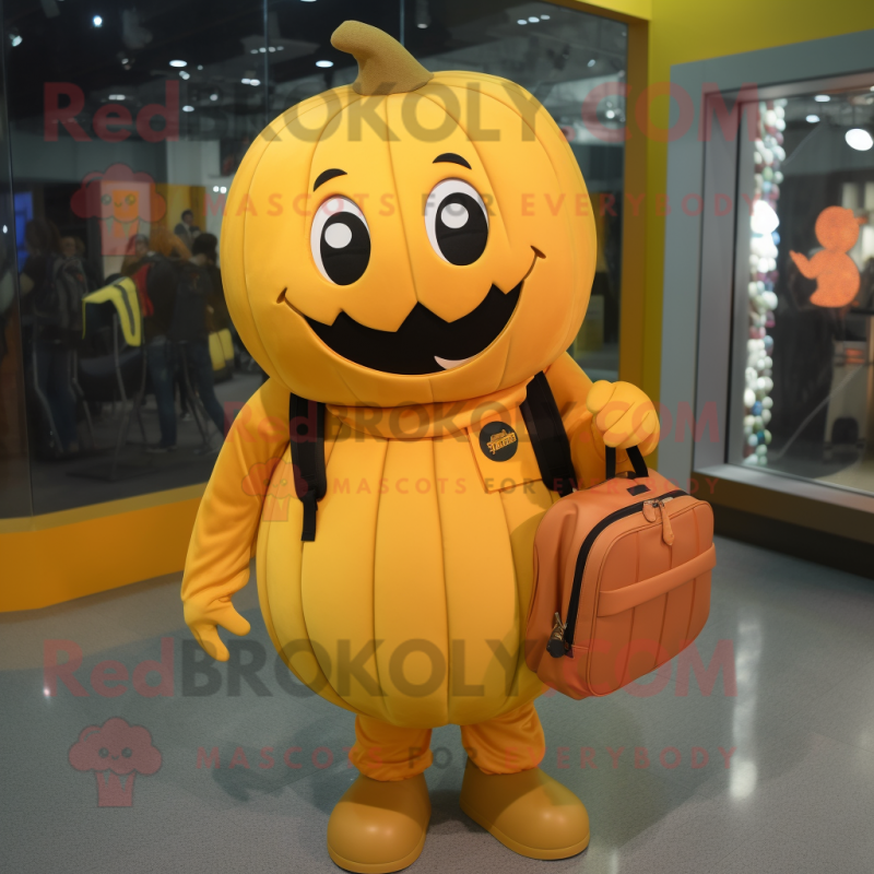 Gold Pumpkin mascot costume character dressed with a Polo Shirt and Messenger bags Gold Pumpkin mascot costume character dressed with a Polo Shirt and Messenger bags