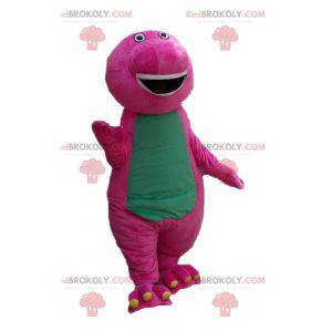 Baculatý a zábavný obří růžový a zelený dinosaur maskot -