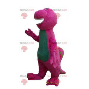 Mascote gigante gigante e engraçado de dinossauro rosa e verde