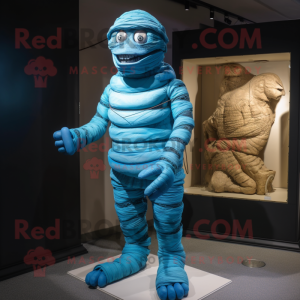 Blue Mummy mascot costume character dressed with a Rash Guard and Suspenders