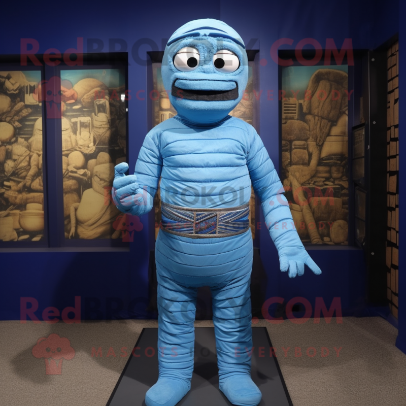 Blue Mummy mascot costume character dressed with a Rash Guard and Suspenders