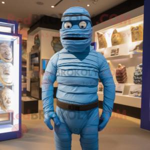 Blue Mummy mascot costume character dressed with a Rash Guard and Suspenders