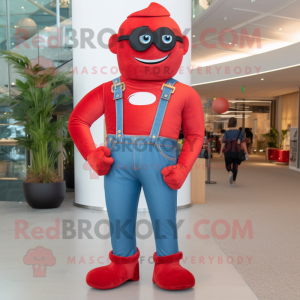 Red Superhero mascot costume character dressed with a Boyfriend Jeans and Suspenders