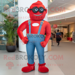 Red Superhero mascot costume character dressed with a Boyfriend Jeans and Suspenders