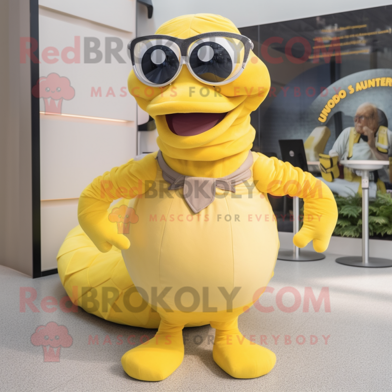 Yellow Titanoboa mascot costume character dressed with a Pleated Skirt and Eyeglasses