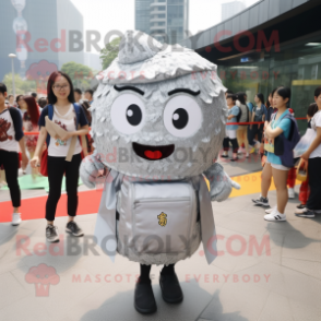 Silver Fried Rice mascot costume character dressed with a Midi Dress and Backpacks