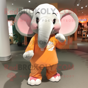 Peach Elephant mascot costume character dressed with a Long Sleeve Tee and Keychains