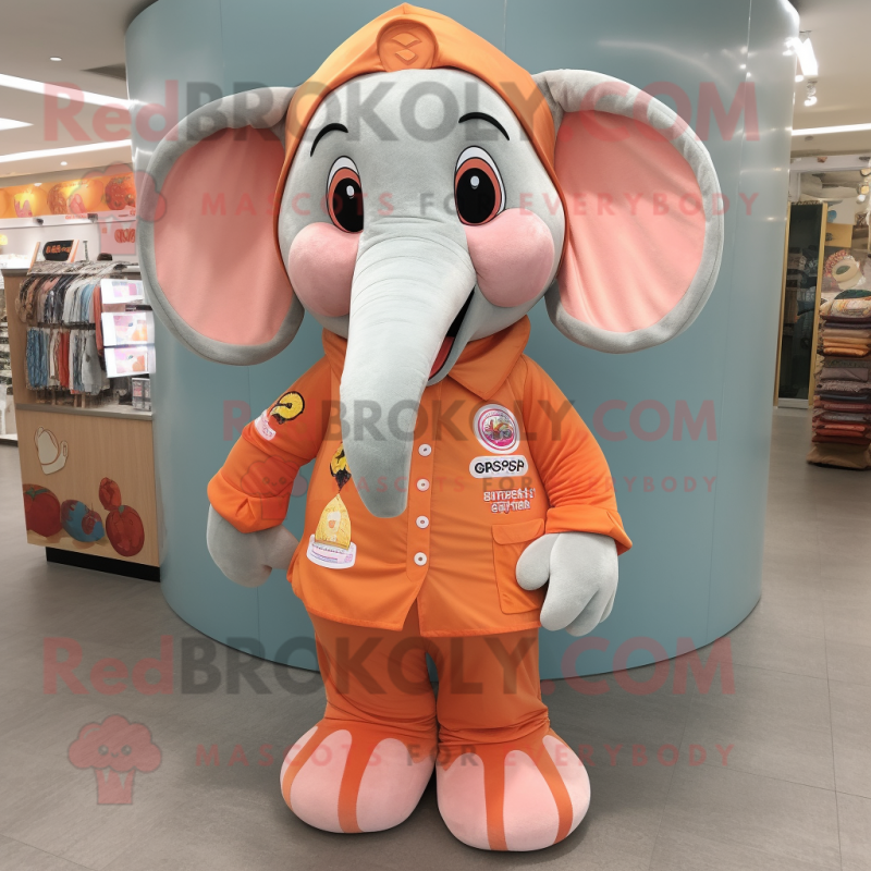Peach Elephant mascot costume character dressed with a Long Sleeve Tee and Keychains Peach Elephant mascot costume character dressed with a Long Sleeve Tee and Keychains