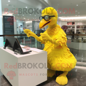 Yellow Dodo Bird mascot costume character dressed with a Wrap Skirt and Reading glasses