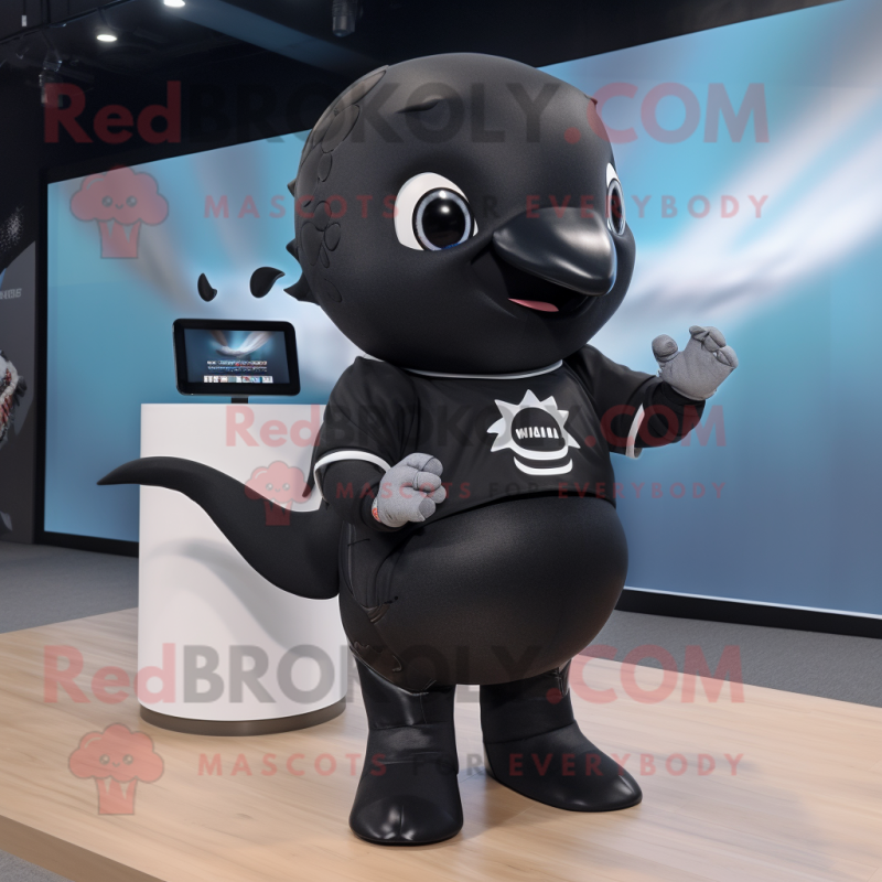 Black Humpback Whale mascot costume character dressed with a T-Shirt and Smartwatches