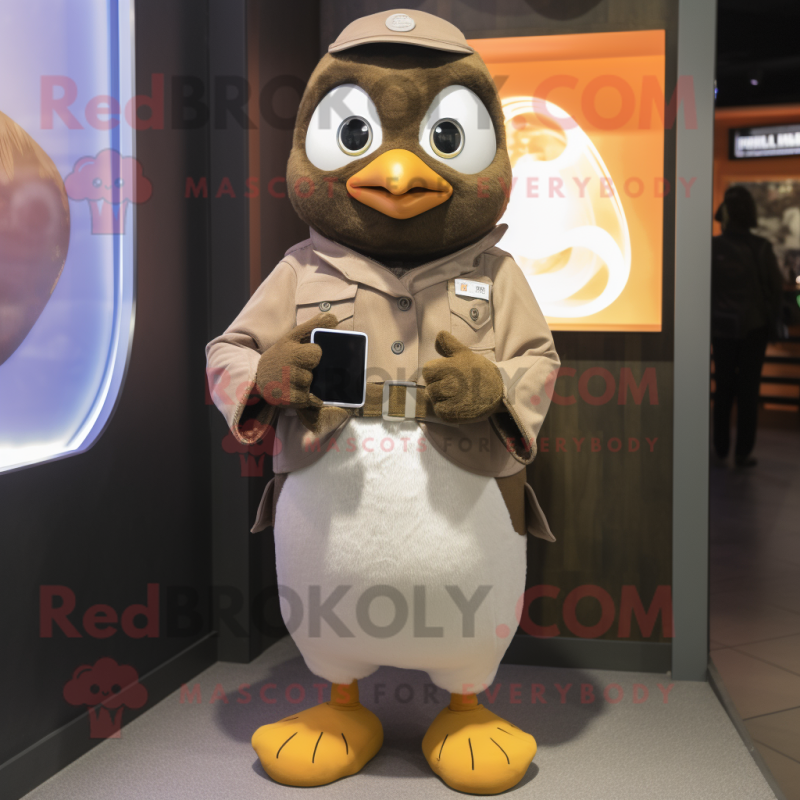 Tan Penguin mascot costume character dressed with a Jumpsuit and Smartwatches