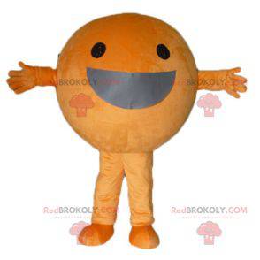 Gigantyczna pomarańczowa maskotka dookoła i uśmiechnięta -