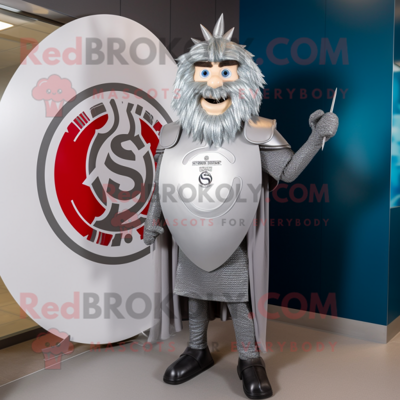 Silver Celtic Shield mascot costume character dressed with a Suit and Hairpins Silver Celtic Shield mascot costume character dressed with a Suit and Hairpins