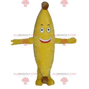 Mascote banana amarela gigante e sorridente - Redbrokoly.com