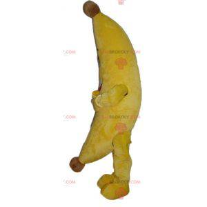 Mascote banana amarela gigante e sorridente - Redbrokoly.com