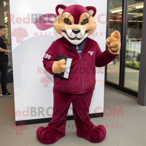 Maroon Puma mascot costume character dressed with a Jacket and Clutch bags