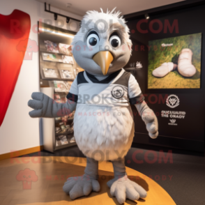 Silver Quail mascot costume character dressed with a Rugby Shirt and Gloves