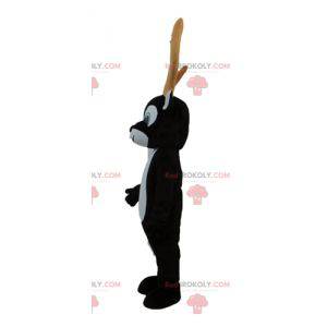 Black and white reindeer mascot with large yellow antlers -