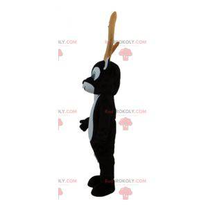 Mascote de rena preto e branco com grandes chifres amarelos -