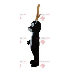 Mascote de rena preto e branco com grandes chifres amarelos -