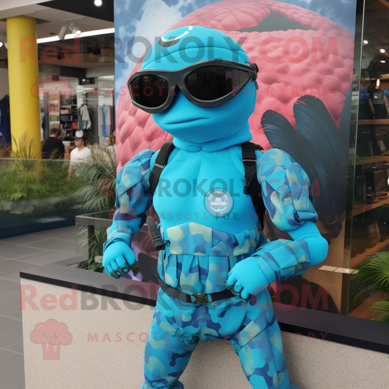 Turquoise Marine Recon mascot costume character dressed with a Swimwear and Bracelets