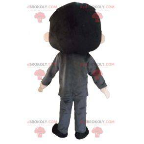 Brown mascotte ragazzo vestito di grigio molto sorridente -
